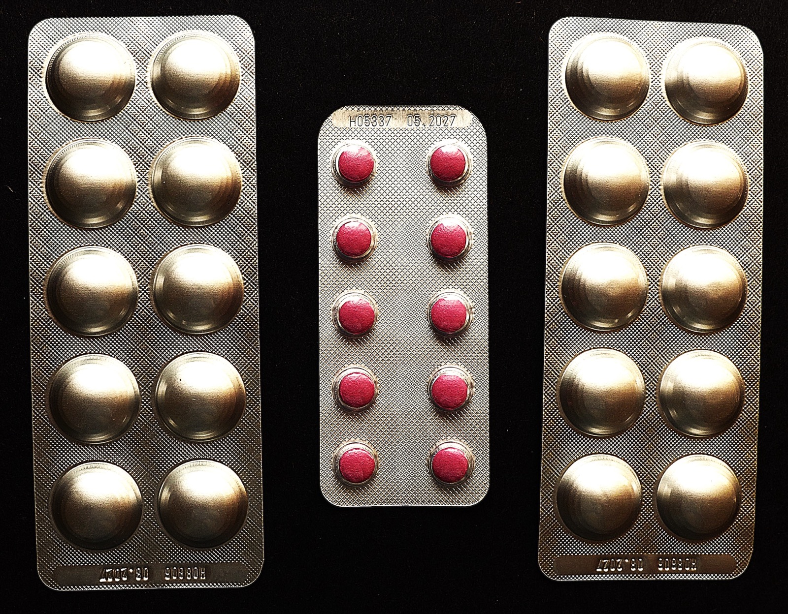 Blister packs of tablets, the products whose adverse-event reports generate the follow-up letters.
