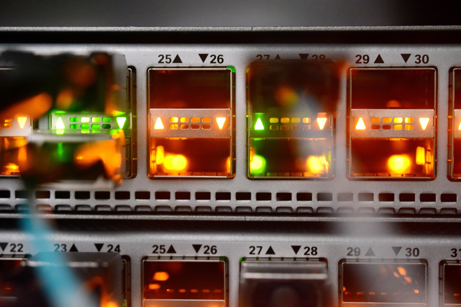 A network switch in a research computing centre, fibre links lit in each numbered port.